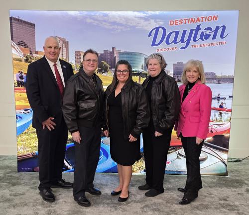 The 2025 Destination Dayton Community Ambassador Award winners, posing in front of a banner that says Destination Dayton in the upper right corner.