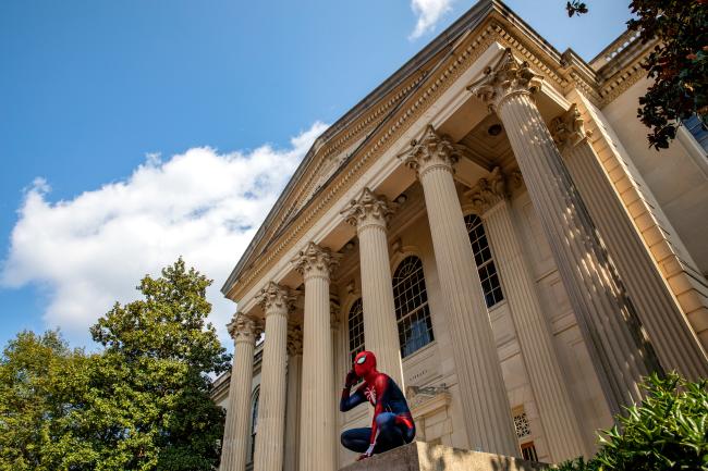 Spiderman perched on marker at Wilson Library UNC Chapel Hill