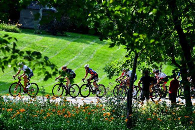 Cyclists racing among green background in Winfield