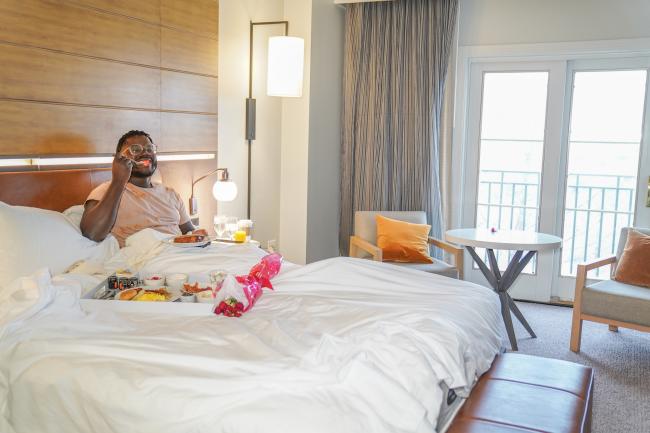 Man eating breakfast in bed