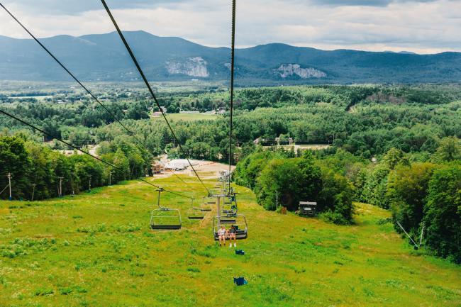 Cranmore Mountain Resort - Three Girls Riding a Chairlift in the Summer with a Mountain View Behind Them