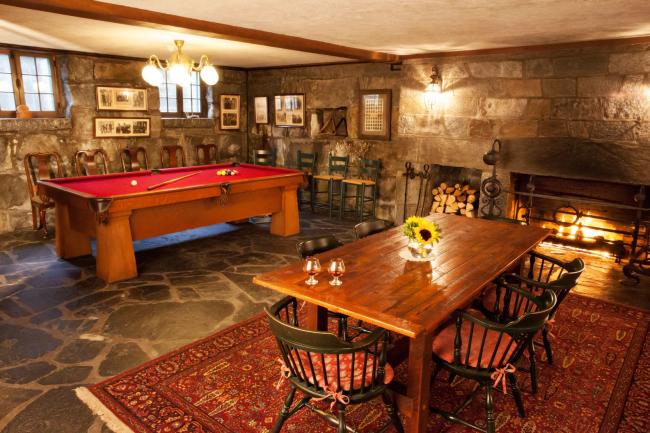 Adair Inn Granite Room - Pool Table, Dinner Table, and Fireplace in Cozy Stone Room at an Inn