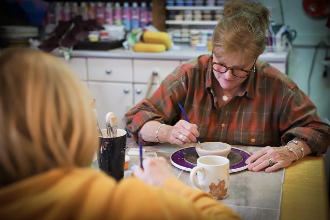 Fired on the Mountain - Two Women Painting Pottery