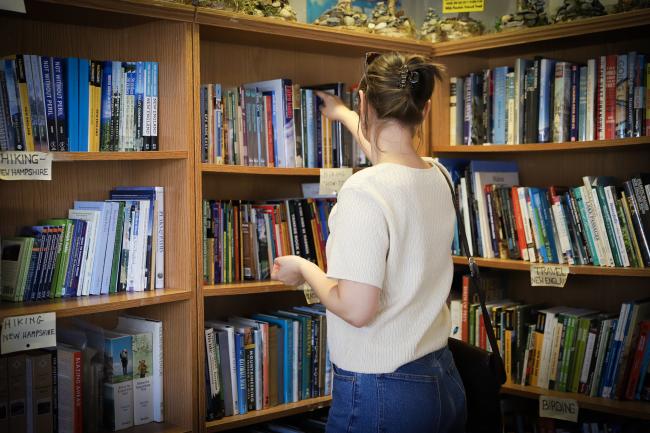 Mountain Wanderer - Woman Looking at Books Inside Bookstore