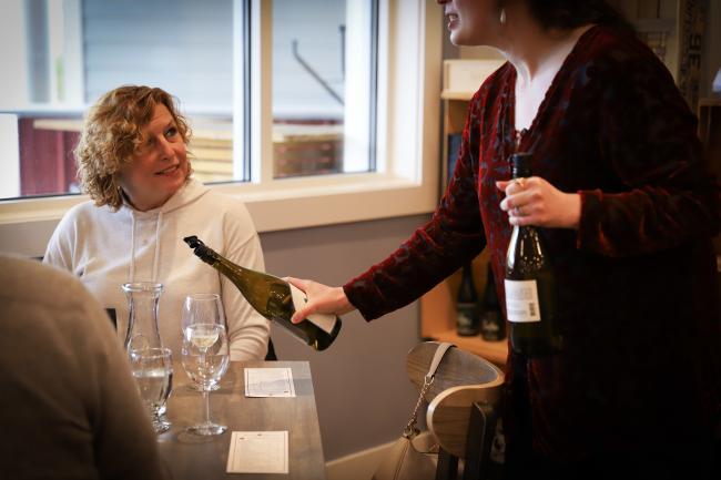 Seven Birches Winery - Woman Smiling as a Wine Sample is Poured for Her