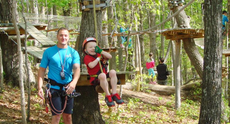 Little Boy Swinging at TreeTop Quest