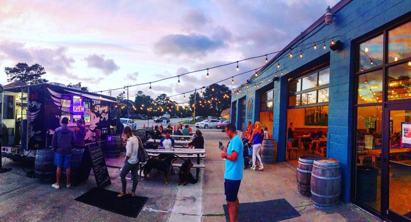 Visitors enjoy the warm summer air and open space at Commonwealth Brewing Company's patio.