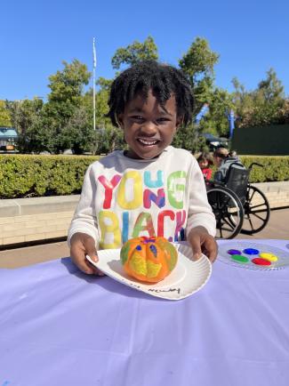 Child painting a pumpkin at the Oklahoma Hall of Fame