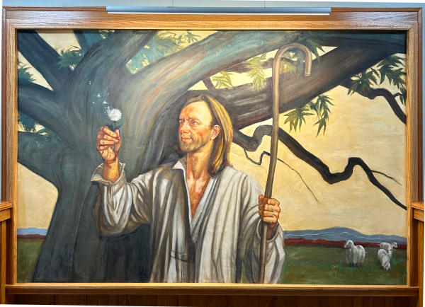 A shepherd in white stands under a tree and holds a staff in one hand and a dandelion in the other. Sheep and rolling hills can be seen behind him.