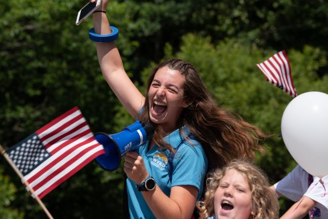 Waterville Valley Recreation Department 4th of July Parade (Two Girls Shouting and Smiling while Holding American Flags)