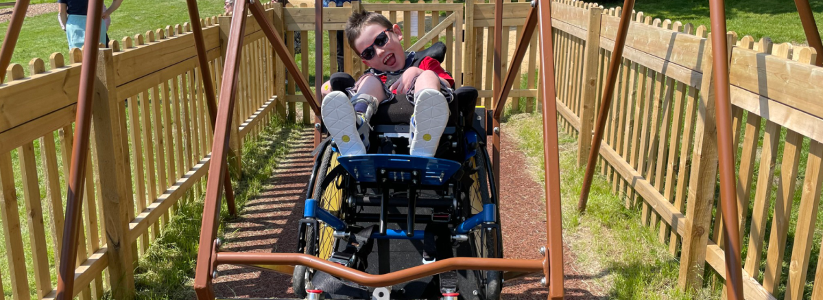 Person on accessible swing at Longdown Activity Farm in the New Forest