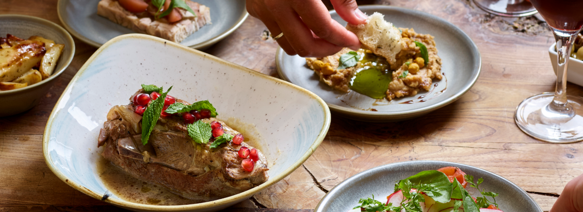 People eating from plates on the table at Careys Manor in the New Forest