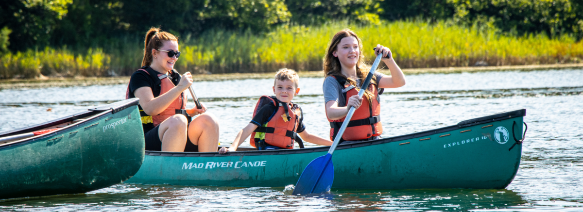 Children canoeing on Beaulieu River in the New Forest with New Forest Activities