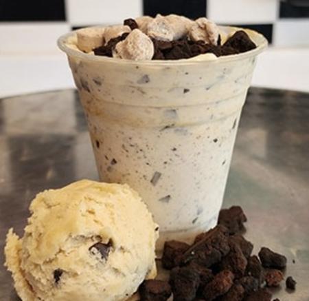 Ice cream and brownie chunks beside the final blended product with raw cookie dough bites on top.