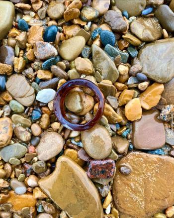 Circle beach glass in rocks by Charlotte Hernandez