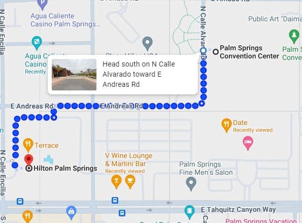 A screenshot of a digital map showing a navigation route with blue dots and a direction prompt instructing to head south on a street, with various location markers and a small inset showing a street view image of the actual location.
