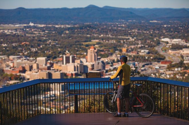 Cyclist at Mill Mountain Overlook admires the view