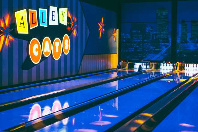 Photo of Alley Cats Entertainment bowling lanes and sign with black light