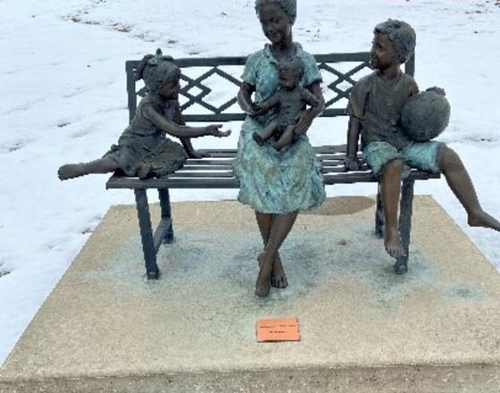 Mother and Children Sitting on a Bench