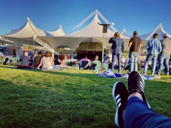 Guest sitting on The Lawn at The Cynthia Woods Mitchell Pavilion