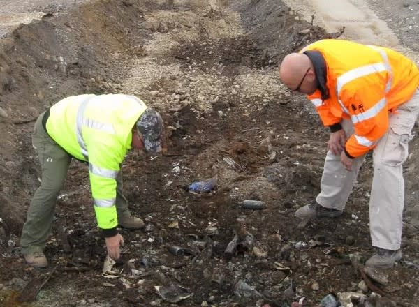 Archaeologists sift through items found in a former garbage dump beneath the runway of Mackinac Island Airport