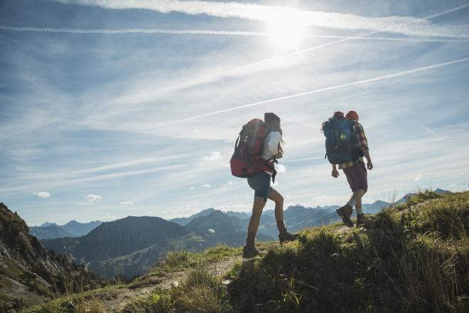 hikers climbing a mountain to enjoy mountain landscape