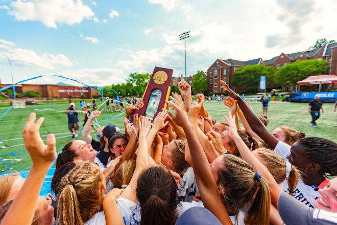 Middlebury Women's Lacrosse Holding NCAA DIII Women's Lacrosse Championship Trophy.