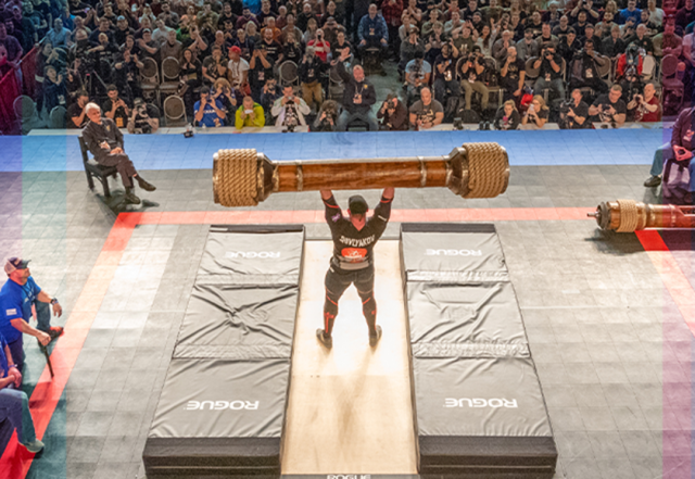 Man lifting weight above head at Arnold Sports Festival
