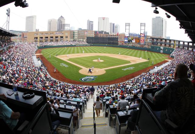 Clippers baseball game at Huntington Park baseball with crowd in seats and skyline in background under blue sky