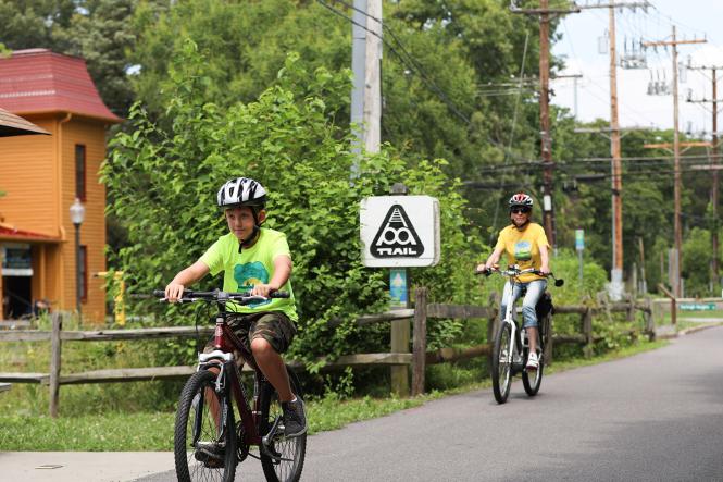 Woman and kid biking the B&A Trail.