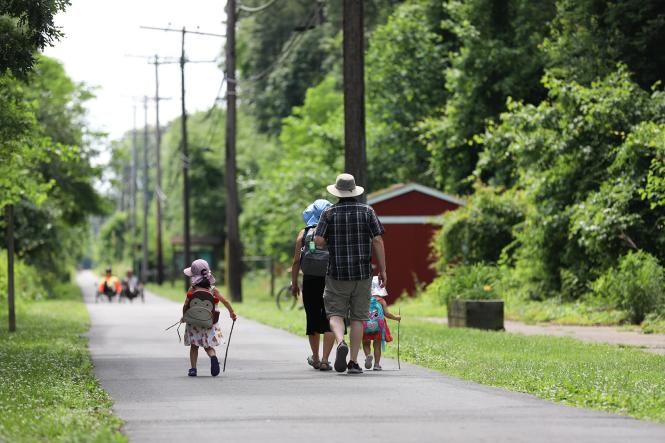 A young family walks along the B&A Trail