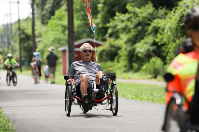 Man on a recumbent bike along the b & A Trail.