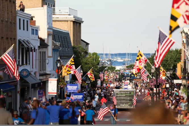 a view to the water down a street during a parade