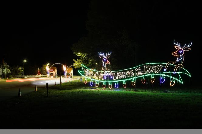 A light display with reindeer spelling out 'Lights on the Bay'