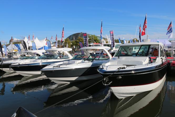 power boats lined up in the water at a dock during the Annapolis Power Boat Show