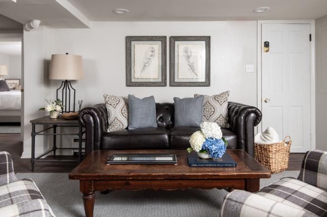 A leather couch and pillows awaits you in the two bedroom family suite