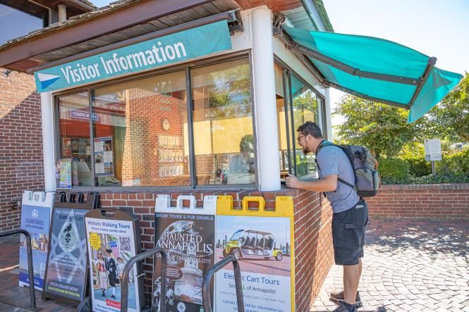 a man asks for directions at a Visitor Information Kiosk