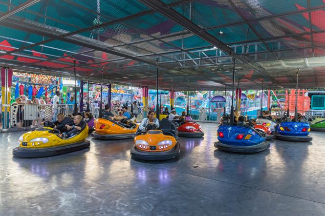 people in bumper cars at a fair