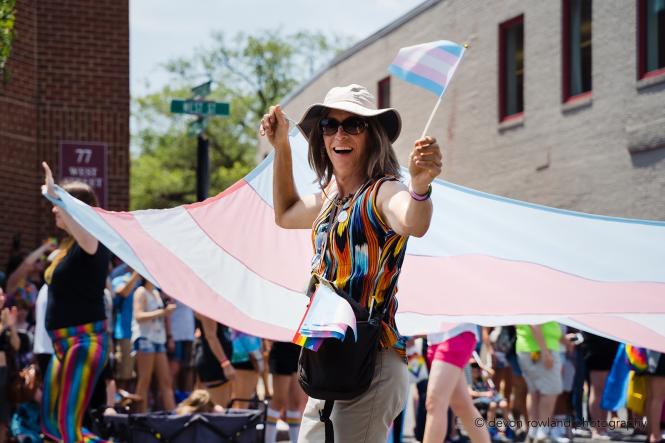 A trans woman holds a trans flag at the Annapolis Pride parade.