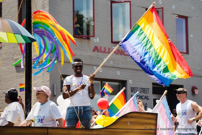 A black man holds a rainbow flag during the Annapolis Pride Parade