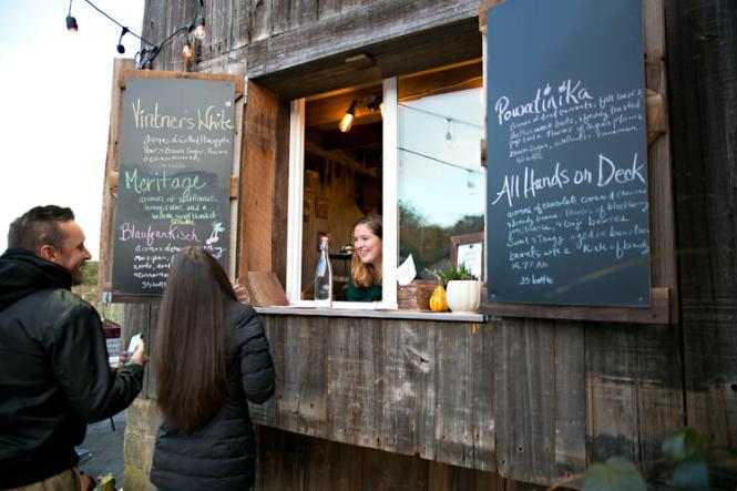 A couple orders wine from the mobile bar at Great Frogs Winery