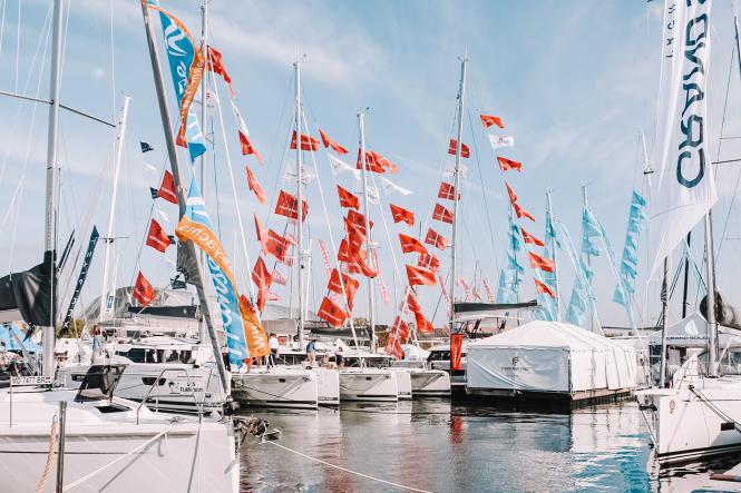 saliboats docked in the water with flags