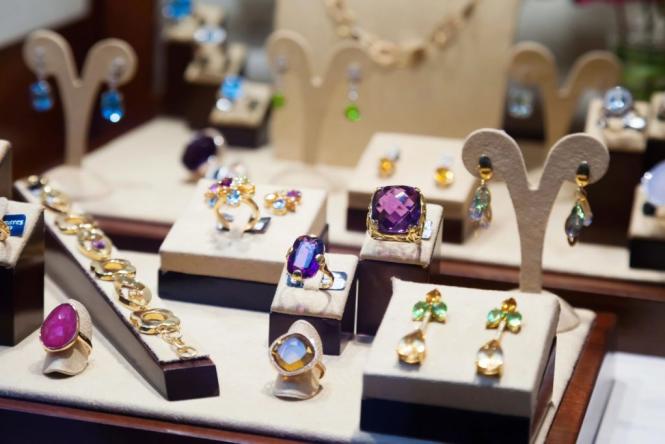 A display of Amethyst and Peridot jewelry from Adore Jewelry & Diamond Center.