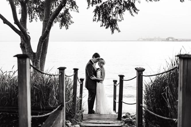 A wedding couple stands waterside at the Chesapeake Bay Beach Club.