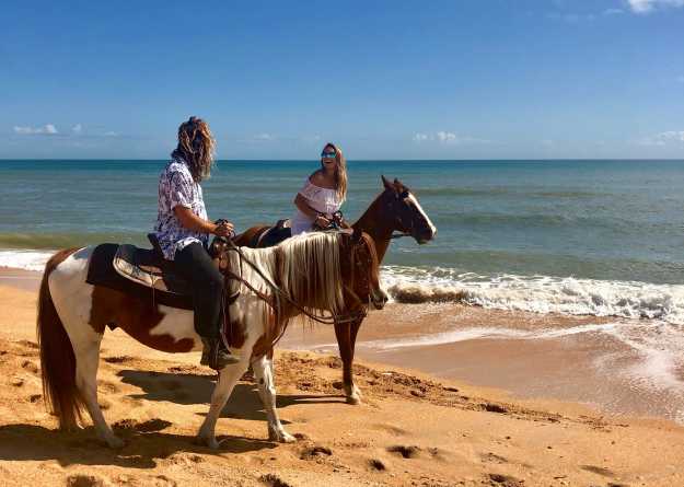 Two People Riding Horses On Flagler Beach