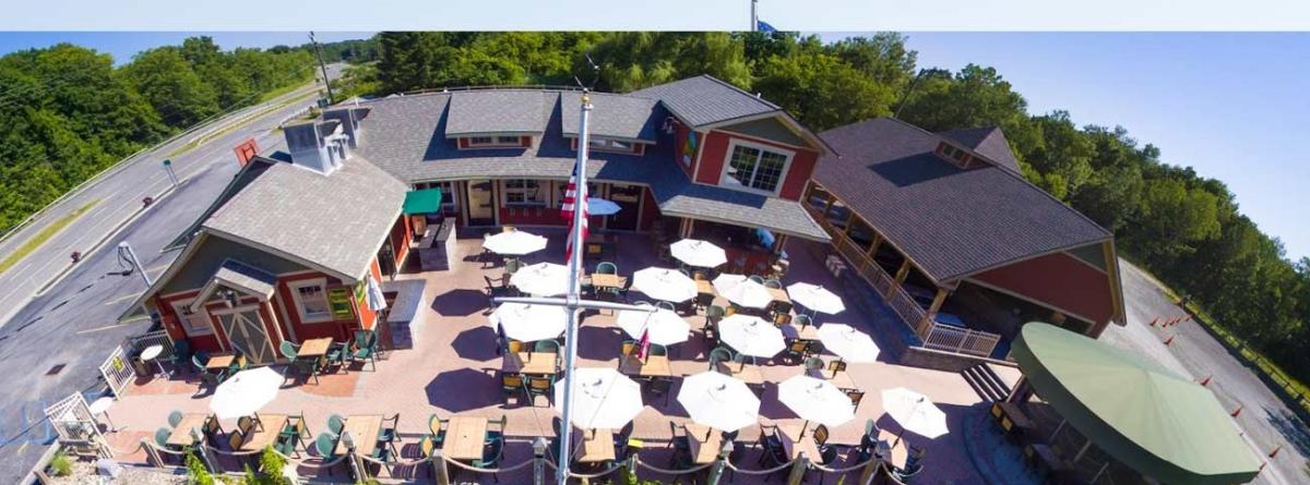 Aerial shot of Mill on Round Lake's patio with white umbrellas