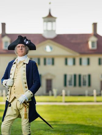 George Washington (interpreter) standing in front of his home, Mount Vernon