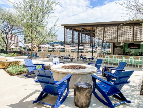 Deck chairs around fire pits at The Lakehouse Waterfront Lounge in Irving, TX