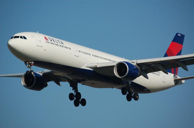 A Delta airplane descends in the sky and prepares for landing in Wichita