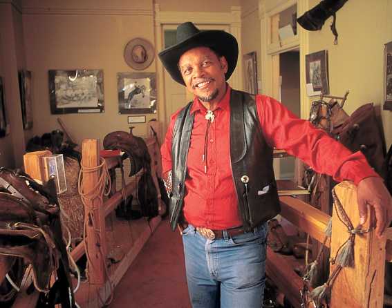 A local cowboy poses inside the Black American West Museum.
